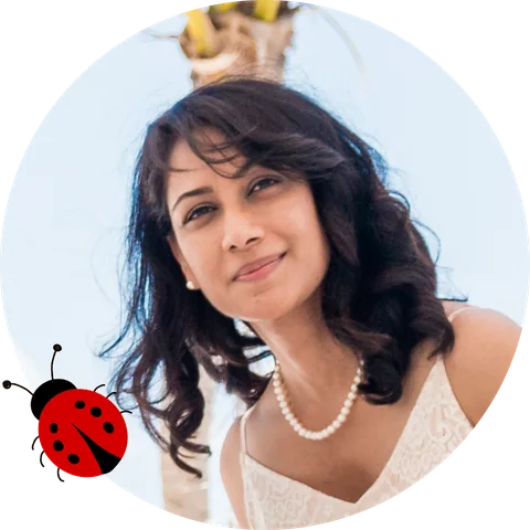 Parveen K., smiling, with a ladybug illustration beside her.